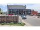 Street view showcasing 'The MAC' building with modern glass facade and street parking at 41 Cortez St, Denver, CO 80221