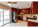 Galley style kitchen with dark wood cabinets and stainless steel appliances at 929 S Nile Way, Aurora, CO 80012