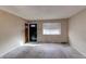 Simple living room with neutral walls and carpeted floors at 929 S Nile Way, Aurora, CO 80012