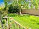 Lush backyard featuring green lawn, mature trees, and a bird bath, creating a serene outdoor space at 16308 E Wyoming Dr, Aurora, CO 80017