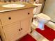 Bathroom featuring a vanity with a granite countertop, classic toilet, and bright red mats at 16308 E Wyoming Dr, Aurora, CO 80017