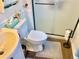 Cozy bathroom featuring a toilet, vanity sink, and shower with glass doors, accented by wood-look flooring at 16308 E Wyoming Dr, Aurora, CO 80017