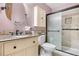 Well-lit bathroom featuring a stone-tiled shower, granite vanity top, and modern fixtures at 16308 E Wyoming Dr, Aurora, CO 80017