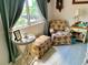 Inviting corner sitting area with tea pot themed chair and ottoman bathed in sunlight at 16308 E Wyoming Dr, Aurora, CO 80017