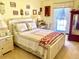 Bright bedroom with a cozy bed, vintage decor, and natural light from the window at 16308 E Wyoming Dr, Aurora, CO 80017