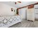 Bedroom featuring white walls, wood floors, and a unique brick accent wall at 16308 E Wyoming Dr, Aurora, CO 80017