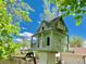 Charming, miniature replica house for birds featuring balconies, columns, and gabled roof at 16308 E Wyoming Dr, Aurora, CO 80017