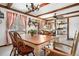 Open dining area showcasing wood beams, ample windows, and seamless flow to adjacent living spaces at 16308 E Wyoming Dr, Aurora, CO 80017