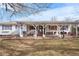 Charming single-story home with a covered porch, white siding, and red shutters at 16308 E Wyoming Dr, Aurora, CO 80017