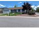 Charming single-story home with a well-manicured lawn, red accents, and mature trees creating an inviting curb appeal at 16308 E Wyoming Dr, Aurora, CO 80017