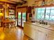 Bright and airy kitchen featuring wooden floors, a large sink, and access to an outdoor patio area at 16308 E Wyoming Dr, Aurora, CO 80017