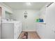 Functional laundry room with washer, dryer, and built-in cabinets at 16308 E Wyoming Dr, Aurora, CO 80017