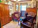 Private sitting room featuring classic wooden furniture, wingback chairs and natural light at 16308 E Wyoming Dr, Aurora, CO 80017