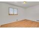 Bright bedroom featuring hardwood floors and a large closet at 5648 E Greenwood Pl, Denver, CO 80222