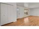 Living room with hardwood floors, built-in shelving and door to entryway at 5648 E Greenwood Pl, Denver, CO 80222