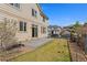 Outdoor space of this house featuring a concrete patio, lawn, and metal fence at 1208 S Valentia Ct, Denver, CO 80247