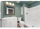 This bathroom features a white sink, wood floors, and a shower with glass door at 1208 S Valentia Ct, Denver, CO 80247