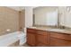 Bathroom with double sink vanity with granite counters, soaking tub, and tiled flooring at 1208 S Valentia Ct, Denver, CO 80247