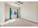 Bedroom showcasing neutral carpet, ceiling fan, and bright window with blue curtains at 1208 S Valentia Ct, Denver, CO 80247
