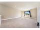 Expansive bonus room with neutral carpeting and good natural light at 1208 S Valentia Ct, Denver, CO 80247