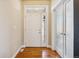 Inviting entryway with hardwood floors, a frosted glass door, a coat closet and a decorative overhead light at 1208 S Valentia Ct, Denver, CO 80247