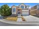 Charming two-story home with a well-maintained lawn, mature tree, attached two car garage and neutral color palette at 1208 S Valentia Ct, Denver, CO 80247