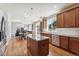 Bright, open kitchen features a center island, granite countertops, wood floors, and stainless steel appliances at 1208 S Valentia Ct, Denver, CO 80247