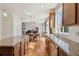 The eat-in kitchen offers a center island, granite counters, and stainless appliances at 1208 S Valentia Ct, Denver, CO 80247