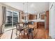 Eat in kitchen featuring wood flooring, sliding glass doors, stainless steel appliances, and modern light fixtures at 1208 S Valentia Ct, Denver, CO 80247