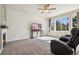 Bright and airy living room featuring a modern fireplace, TV, carpeted flooring, and large windows at 1208 S Valentia Ct, Denver, CO 80247