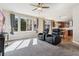 Living room overlooking the eat in kitchen area, with plush carpeting, and comfortable recliners with cup holders at 1208 S Valentia Ct, Denver, CO 80247