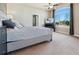 Comfortable main bedroom features large window, ceiling fan, television, and ensuite bathroom at 1208 S Valentia Ct, Denver, CO 80247
