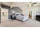 The main bedroom features a tray ceiling, en-suite bathroom, and carpeted floor at 1208 S Valentia Ct, Denver, CO 80247