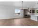 Open floor plan with view of the kitchen featuring a center island, stainless appliances, and hardwood floors at 14281 Currant, Broomfield, CO 80020