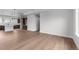 An open-concept living room featuring new wood floors and neutral walls, transitioning into a modern kitchen at 14281 Currant, Broomfield, CO 80020