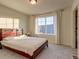 Bedroom with large window and carpeted floor at 16198 E 111Th Pl, Commerce City, CO 80022