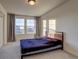 Bedroom with large window and wood-framed bed at 16198 E 111Th Pl, Commerce City, CO 80022
