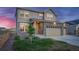 Two-story home with stone and siding exterior, and two-car garage at 16198 E 111Th Pl, Commerce City, CO 80022