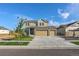 Two-story house with stone and beige siding, two-car garage, and landscaping at 16198 E 111Th Pl, Commerce City, CO 80022