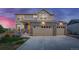 Two-story house with stone and beige siding, two-car garage, and landscaping at 16198 E 111Th Pl, Commerce City, CO 80022
