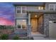 Two-story home with stone and siding exterior, and two-car garage at 16198 E 111Th Pl, Commerce City, CO 80022