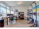 Home office with built-in shelving and hardwood floors at 16198 E 111Th Pl, Commerce City, CO 80022