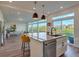 Modern kitchen with island, stainless steel appliances, and view of backyard at 16198 E 111Th Pl, Commerce City, CO 80022
