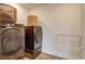 Laundry room with washer, dryer, and shelving at 16198 E 111Th Pl, Commerce City, CO 80022