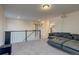 Spacious loft area with sectional sofa, media projector, and balcony overlooking the lower level at 16198 E 111Th Pl, Commerce City, CO 80022