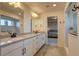 Main bathroom with double vanity and access to bedroom at 16198 E 111Th Pl, Commerce City, CO 80022