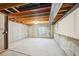 Unfinished basement featuring concrete walls, exposed ceiling with wooden beams, and a small window at 11565 Decatur St # 7D, Denver, CO 80234
