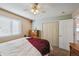 Bedroom with double doors to closet and ceiling fan at 11565 Decatur St # 7D, Denver, CO 80234