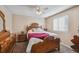 Bedroom with wood furniture and ceiling fan at 11565 Decatur St # 7D, Denver, CO 80234