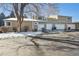 Rear view showing attached garage and building exterior at 11565 Decatur St # 7D, Denver, CO 80234